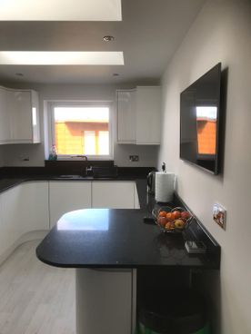 Handleless High Gloss Light Grey Kitchen with Internal & External Curved Doors